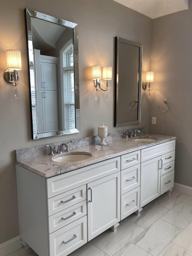4922 Saint Annes Dr, Waunakee, WI 53597 - full bath with double vanity, baseboards, a sink, and marble finish floor