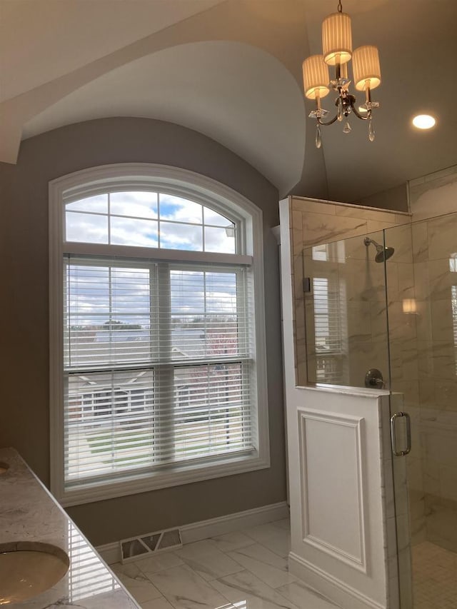 4922 Saint Annes Dr, Waunakee, WI 53597 - bathroom featuring baseboards, a chandelier, a wealth of natural light, and marble finish floor