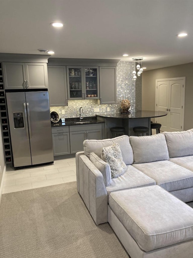 4922 Saint Annes Dr, Waunakee, WI 53597 - interior space featuring stainless steel refrigerator with ice dispenser, dark countertops, gray cabinetry, and a sink