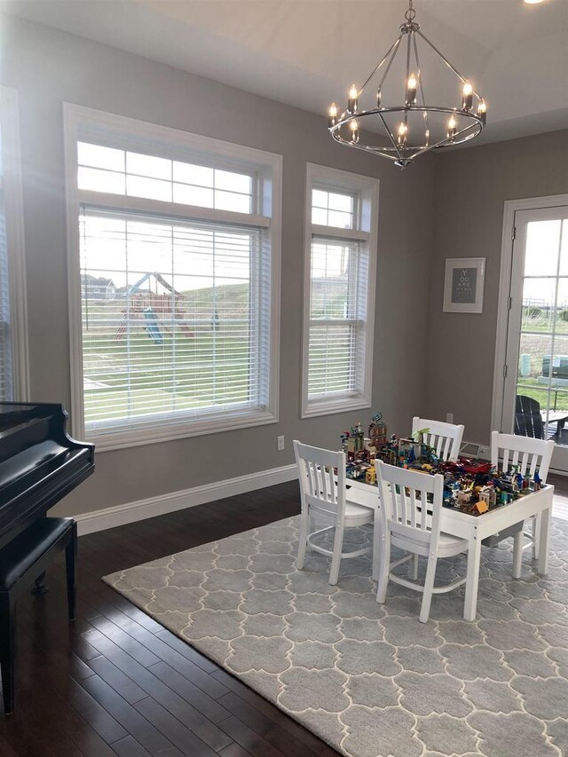 4922 Saint Annes Dr, Waunakee, WI 53597 - dining room featuring baseboards, a chandelier, and wood finished floors