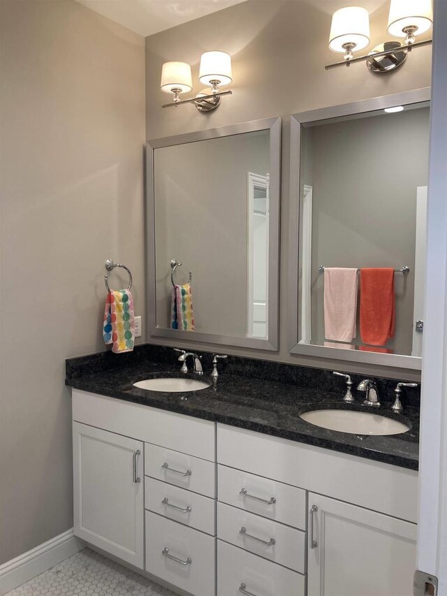 4922 Saint Annes Dr, Waunakee, WI 53597 - bathroom featuring a sink, baseboards, and double vanity