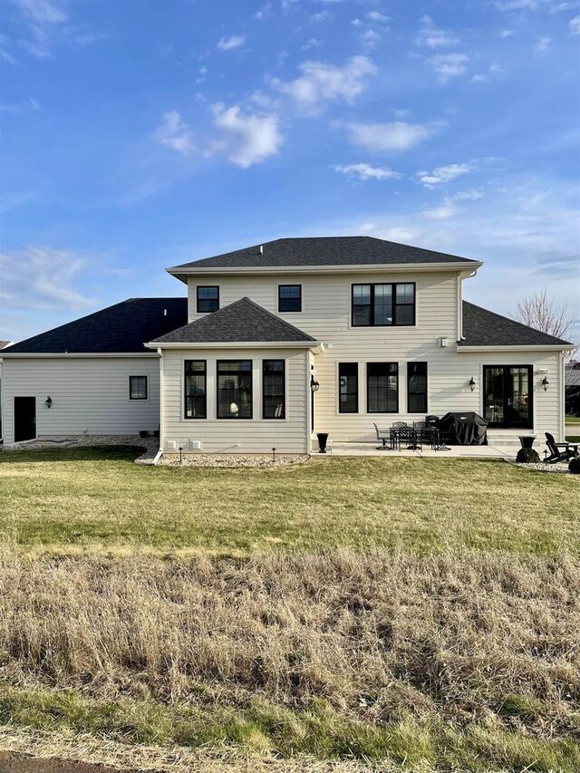 4922 Saint Annes Dr, Waunakee, WI 53597 - back of property featuring a patio, roof with shingles, and a yard