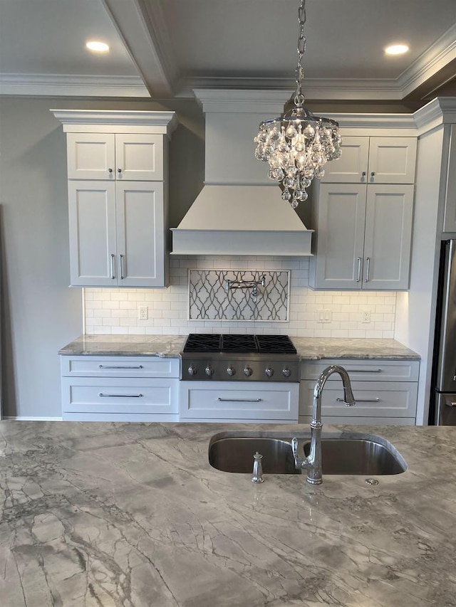 4922 Saint Annes Dr, Waunakee, WI 53597 - kitchen featuring appliances with stainless steel finishes, tasteful backsplash, a sink, custom exhaust hood, and ornamental molding