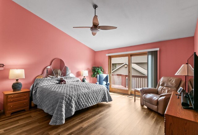 bedroom featuring ceiling fan, wood finished floors, vaulted ceiling, and access to exterior