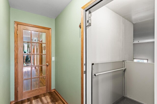 doorway with dark wood-style floors