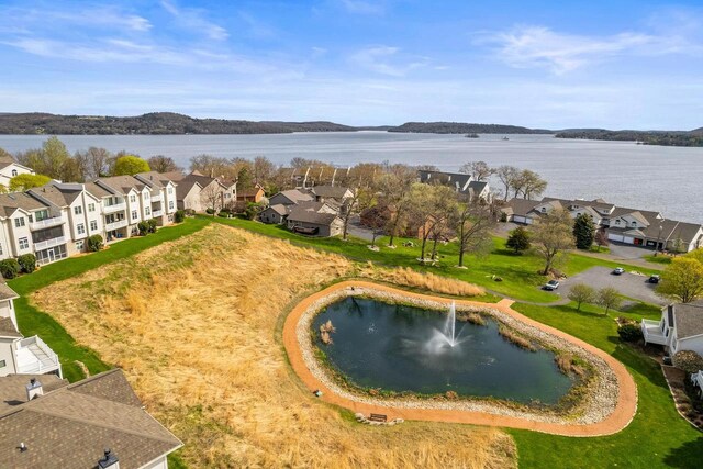drone / aerial view with a water view and a residential view