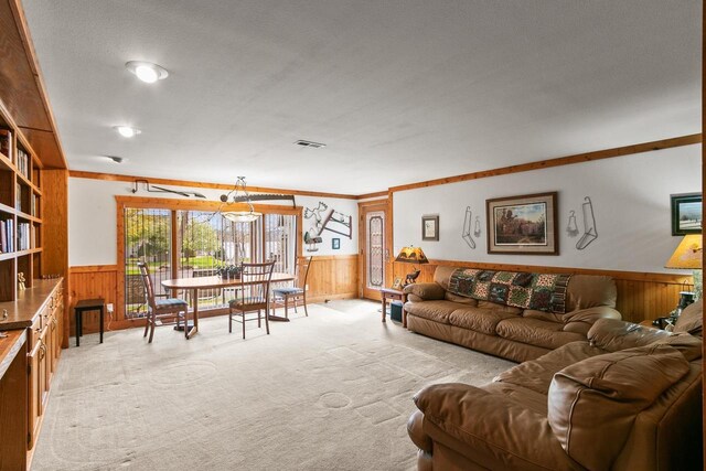living room with wooden walls, a wainscoted wall, and visible vents