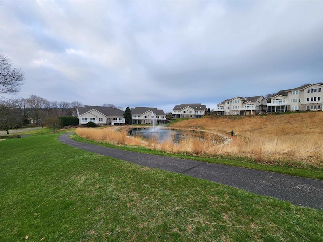 view of street with a water view and a residential view