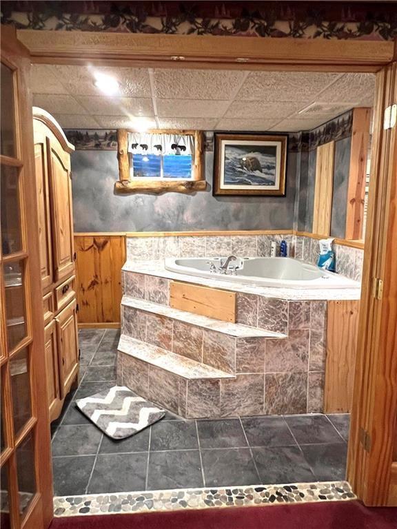 13541 W Whispering Pine Trl, Hayward, WI 54843 - full bathroom with a bath, tile patterned flooring, and wainscoting
