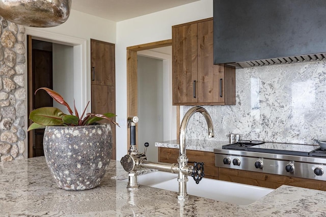 9458 Warner Rd, Winneconne, WI 54986 - kitchen featuring custom exhaust hood, tasteful backsplash, and light stone counters