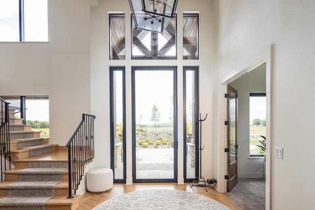 9458 Warner Rd, Winneconne, WI 54986 - entrance foyer with healthy amount of natural light, a towering ceiling, stairs, and a chandelier