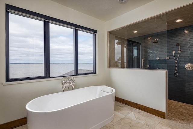 9458 Warner Rd, Winneconne, WI 54986 - bathroom featuring walk in shower, a soaking tub, and a water view