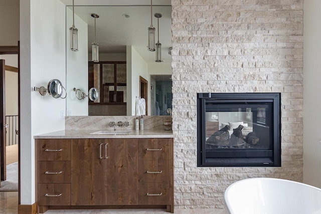 9458 Warner Rd, Winneconne, WI 54986 - full bathroom with a freestanding tub, vanity, and a multi sided fireplace