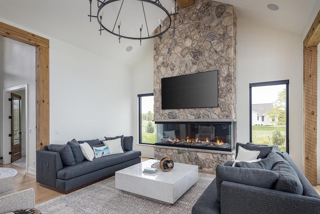 9458 Warner Rd, Winneconne, WI 54986 - living room featuring wood finished floors, high vaulted ceiling, and a stone fireplace