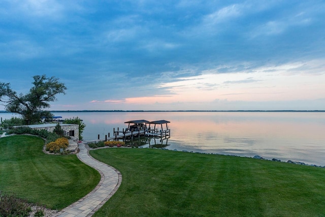 9458 Warner Rd, Winneconne, WI 54986 - dock featuring boat lift, a water view, and a yard