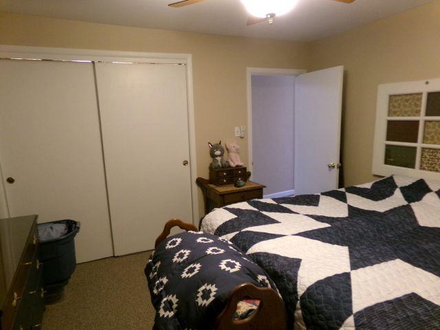 carpeted bedroom with a closet and ceiling fan