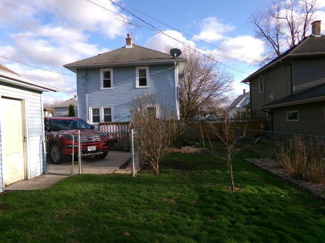 rear view of property with a yard and fence private yard