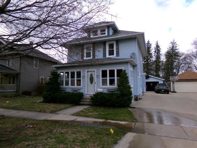 traditional style home with a detached garage