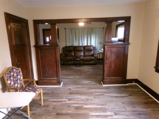 living room featuring baseboards and wood finished floors