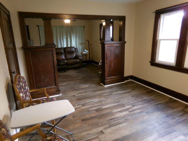 living area featuring baseboards and wood finished floors