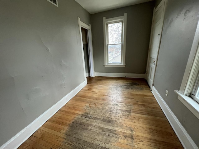 unfurnished bedroom featuring hardwood / wood-style floors and baseboards
