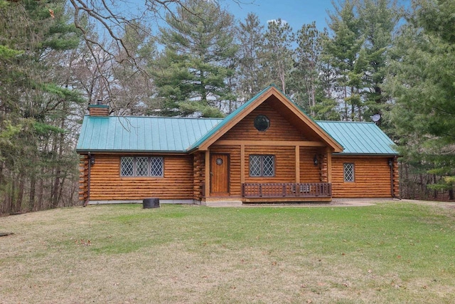 N7589 Lakeside Dr, Portage, WI 53901 - log-style house with metal roof, a front lawn, log siding, and a chimney