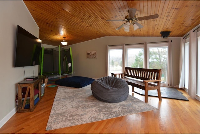 interior space with lofted ceiling, a wealth of natural light, a ceiling fan, and wood ceiling