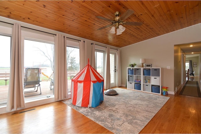 rec room featuring vaulted ceiling, wooden ceiling, visible vents, ceiling fan, and wood finished floors