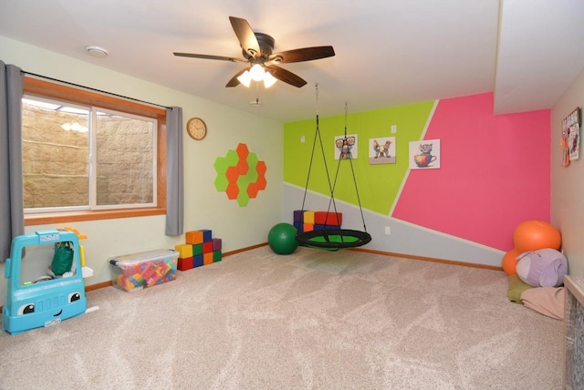 recreation room with carpet, baseboards, and ceiling fan