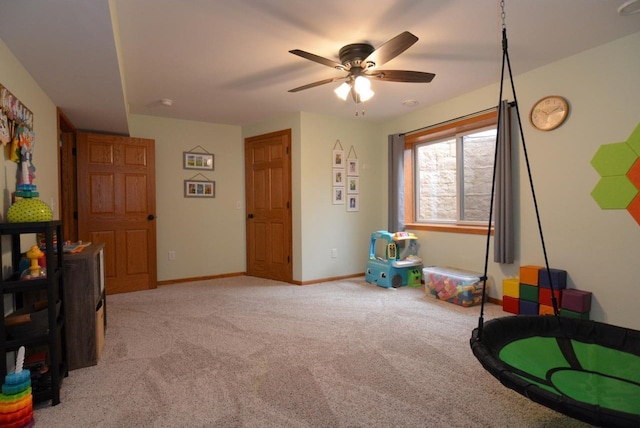 playroom featuring light colored carpet, baseboards, and a ceiling fan