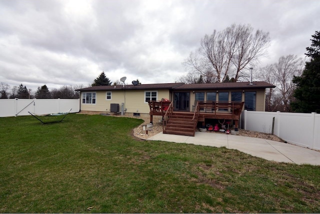 rear view of property featuring a deck, a patio area, a fenced backyard, cooling unit, and a lawn