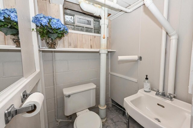 half bath with toilet and a sink