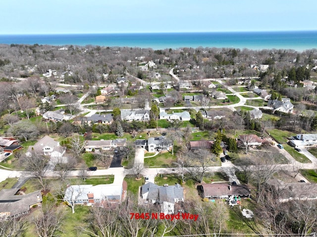 birds eye view of property with a residential view and a water view