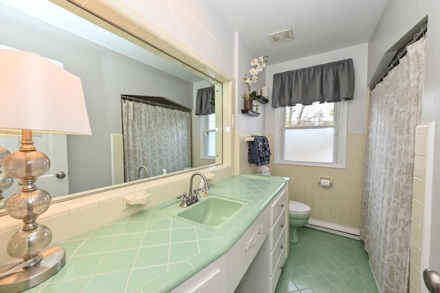 bathroom with visible vents, toilet, tile walls, tile patterned floors, and vanity