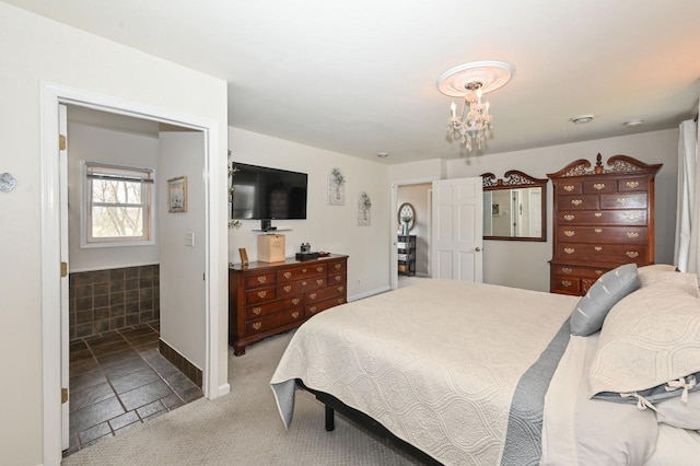 carpeted bedroom featuring baseboards and a notable chandelier