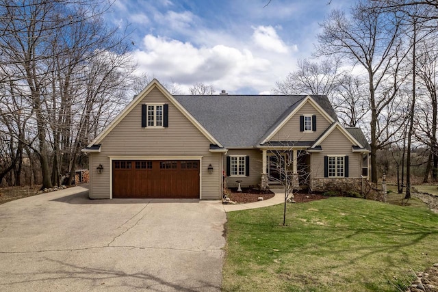 craftsman-style house featuring a front lawn, stone siding, concrete driveway, an attached garage, and a shingled roof