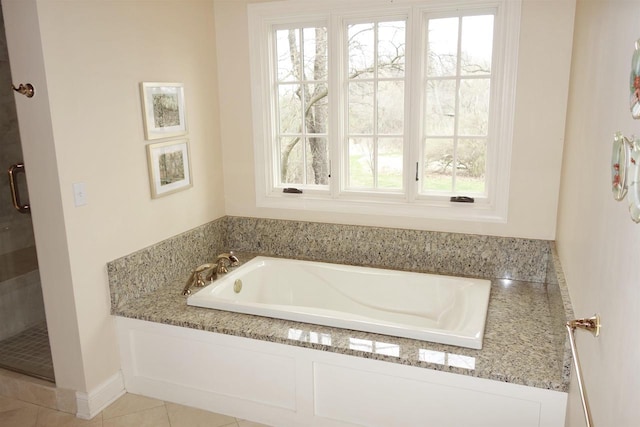 full bathroom with a bath and a shower stall
