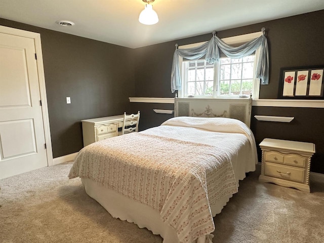 carpeted bedroom with baseboards and visible vents
