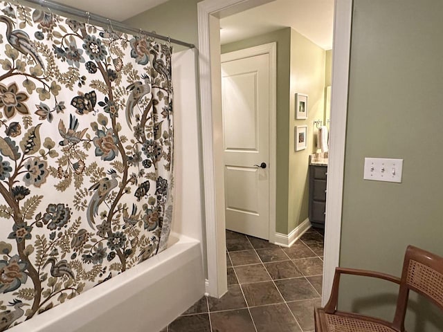 full bathroom with baseboards, vanity, and tile patterned floors