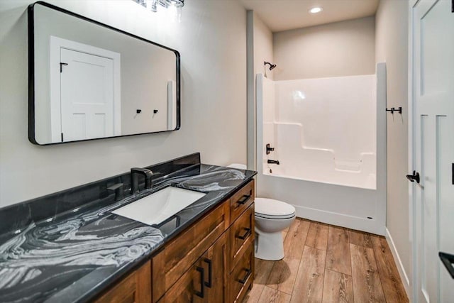 4021 Red Hawk Run, Black Earth, WI 53515 - bathroom featuring bathing tub / shower combination, toilet, recessed lighting, wood finished floors, and vanity
