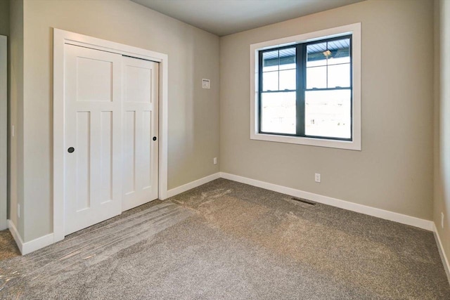 4021 Red Hawk Run, Black Earth, WI 53515 - unfurnished bedroom featuring a closet, carpet, visible vents, and baseboards