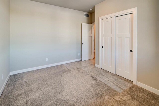 4021 Red Hawk Run, Black Earth, WI 53515 - unfurnished bedroom with baseboards, carpet flooring, visible vents, and a closet