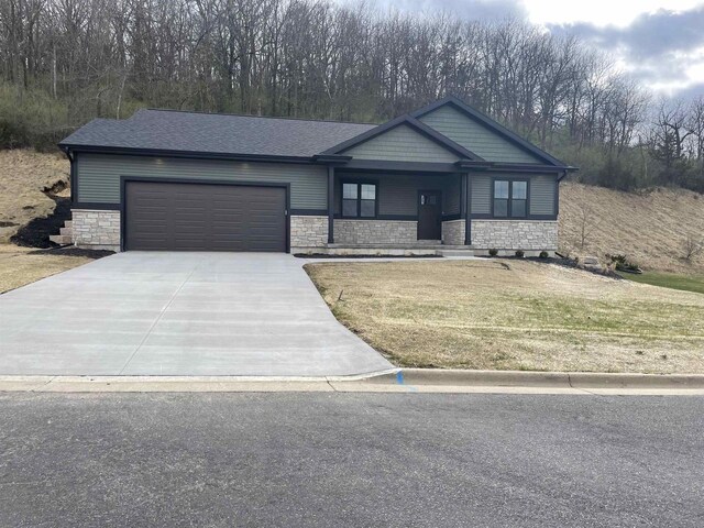 4021 Red Hawk Run, Black Earth, WI 53515 - view of front of property featuring an attached garage, driveway, a porch, and stone siding