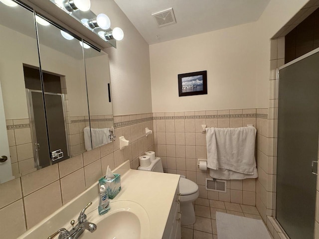 full bathroom with visible vents, a shower stall, and tile walls