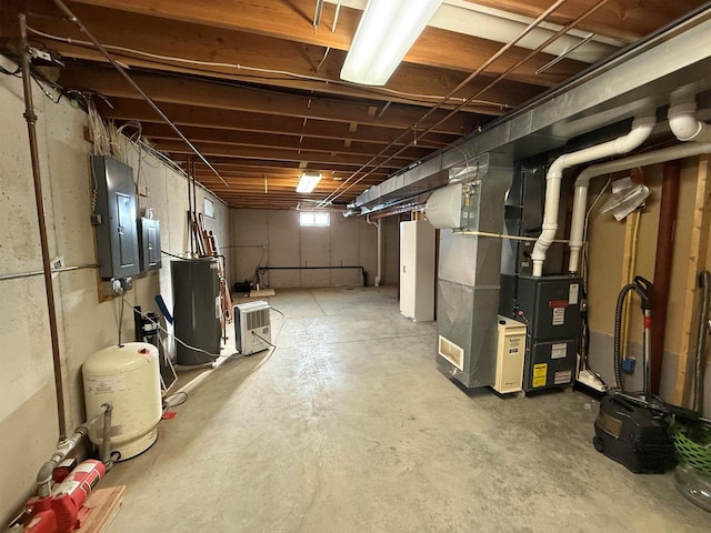 below grade area featuring water heater and electric panel