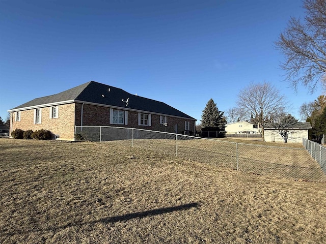 view of home's exterior featuring brick siding and a fenced backyard
