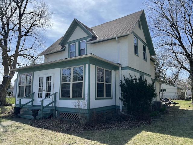 201 Bonito St, Walworth, WI 53184 - rear view of property featuring stucco siding, a lawn, a shingled roof, and french doors