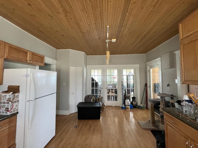 201 Bonito St, Walworth, WI 53184 - kitchen with freestanding refrigerator, dark countertops, light wood finished floors, and french doors