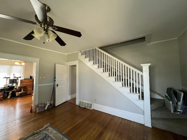 201 Bonito St, Walworth, WI 53184 - unfurnished living room with wood finished floors, visible vents, a ceiling fan, and stairway