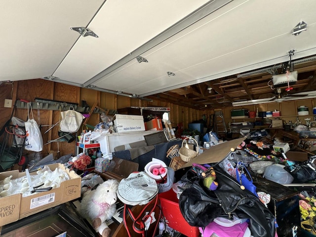 201 Bonito St, Walworth, WI 53184 - garage featuring a garage door opener and wood walls